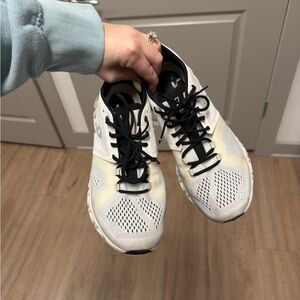 On Running Cream and Black Athletic Shoes